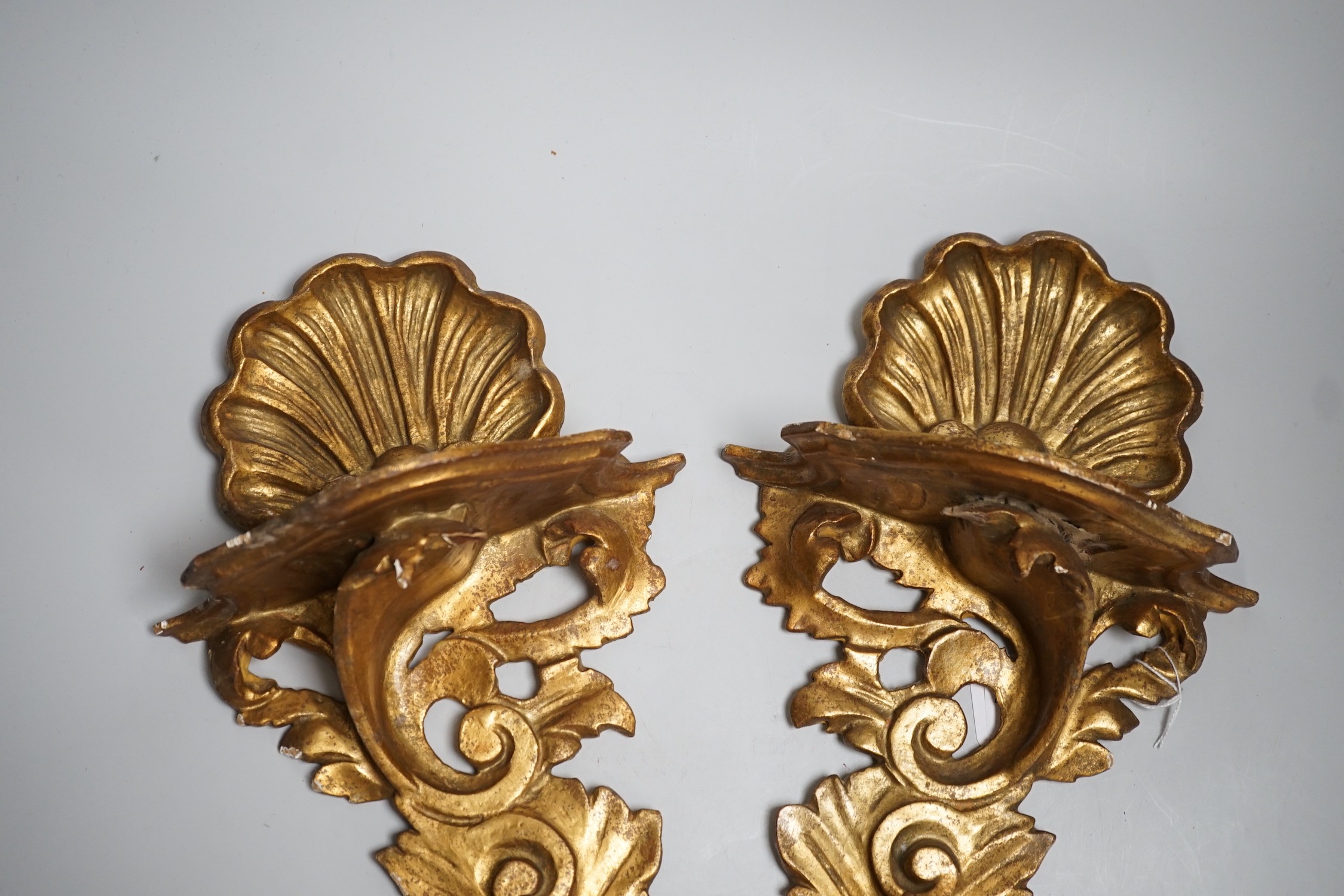 A pair of Italian gilt wood wall brackets in rococo style, early 20th century, 44cm long